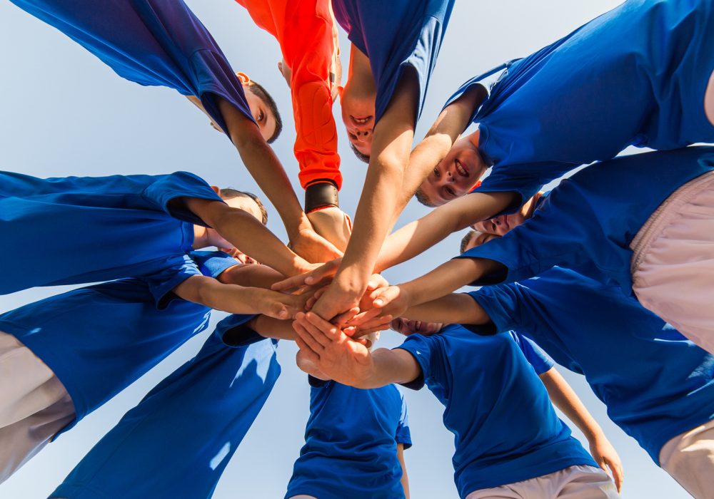 kids soccer team in huddle